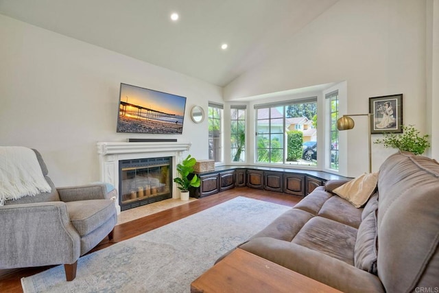 1675 Bronco Way, Oceanside, CA 92057 - living room with high vaulted ceiling, recessed lighting, a fireplace with flush hearth, and wood finished floors