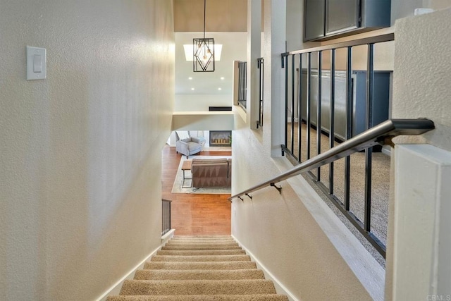 1675 Bronco Way, Oceanside, CA 92057 - staircase with a textured wall, wood finished floors, and a chandelier