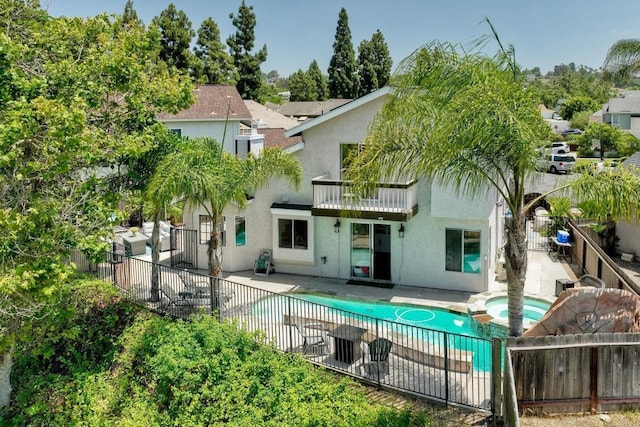 1675 Bronco Way, Oceanside, CA 92057 - rear view of property featuring a balcony, a fenced backyard, stucco siding, and a patio