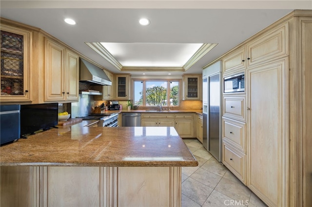 29603 Highpoint Rd, Rancho Palos Verdes, CA 90275 - kitchen with wall chimney range hood, light brown cabinetry, built in appliances, a peninsula, and a raised ceiling