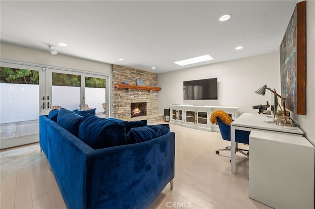 29603 Highpoint Rd, Rancho Palos Verdes, CA 90275 - living area featuring light wood-style floors, french doors, a stone fireplace, and recessed lighting