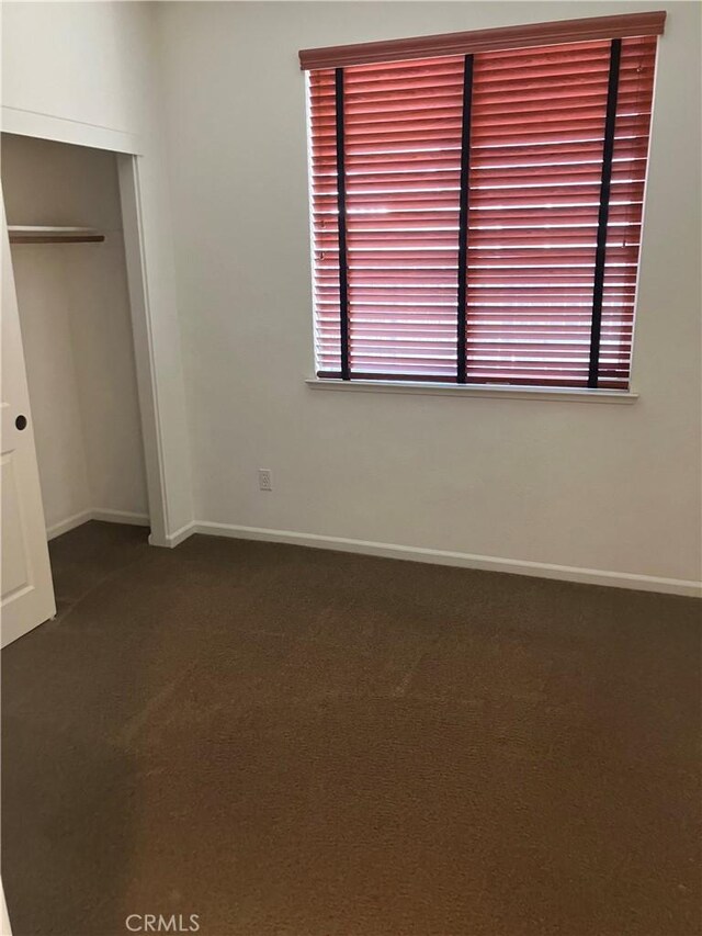1830 Nevada St, Gridley, CA 95948 - unfurnished bedroom with dark carpet and a closet