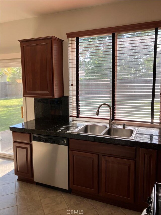 1830 Nevada St, Gridley, CA 95948 - kitchen with stainless steel dishwasher, healthy amount of natural light, and light tile patterned flooring