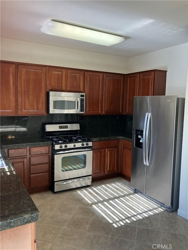 1830 Nevada St, Gridley, CA 95948 - kitchen with appliances with stainless steel finishes, backsplash, light tile patterned flooring, and brown cabinetry