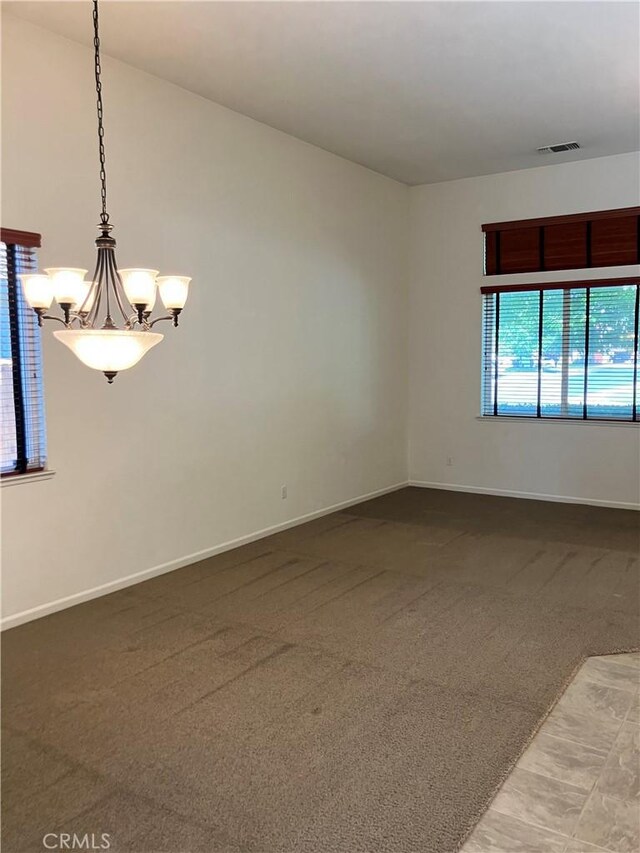 1830 Nevada St, Gridley, CA 95948 - carpeted empty room with a chandelier and baseboards