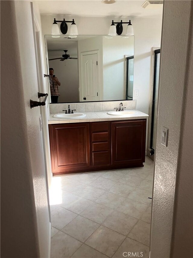 1830 Nevada St, Gridley, CA 95948 - bathroom with double vanity, ceiling fan, and tile patterned floors