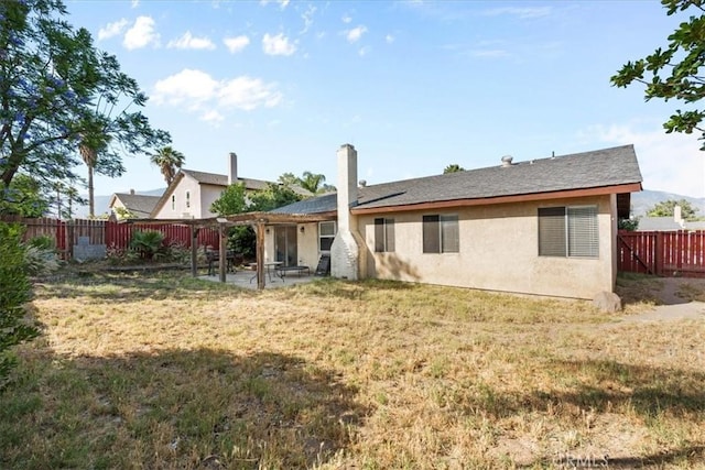 2271 Stanford St, San Bernardino, CA 92407 - rear view of house with a fenced backyard, a patio area, and stucco siding