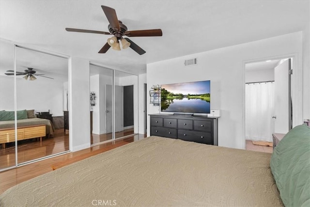 2271 Stanford St, San Bernardino, CA 92407 - bedroom with multiple closets, wood finished floors, a ceiling fan, and connected bathroom