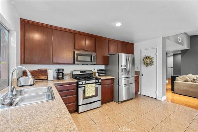 2271 Stanford St, San Bernardino, CA 92407 - kitchen with appliances with stainless steel finishes, light countertops, and light tile patterned floors