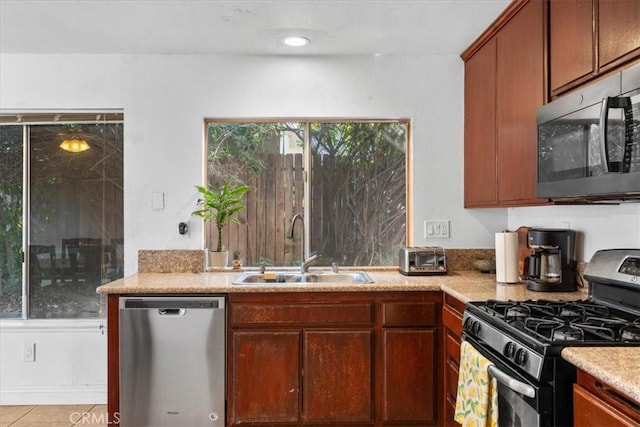 2271 Stanford St, San Bernardino, CA 92407 - kitchen with appliances with stainless steel finishes, light countertops, and light tile patterned floors