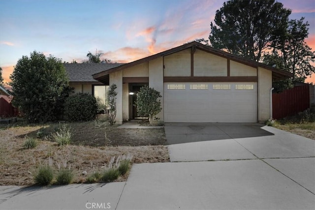 2271 Stanford St, San Bernardino, CA 92407 - view of front of house with an attached garage, driveway, and stucco siding