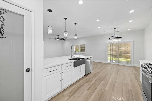 3838 Balmont St, Lancaster, CA 93536 - kitchen featuring stainless steel appliances, a chandelier, recessed lighting, white cabinets, and healthy amount of natural light
