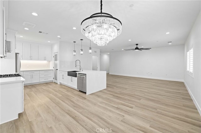 3838 Balmont St, Lancaster, CA 93536 - kitchen with appliances with stainless steel finishes, ceiling fan, light countertops, recessed lighting, and white cabinets