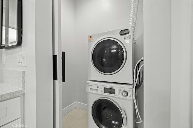 3838 Balmont St, Lancaster, CA 93536 - laundry area featuring estacked washer and dryer and light tile patterned floors