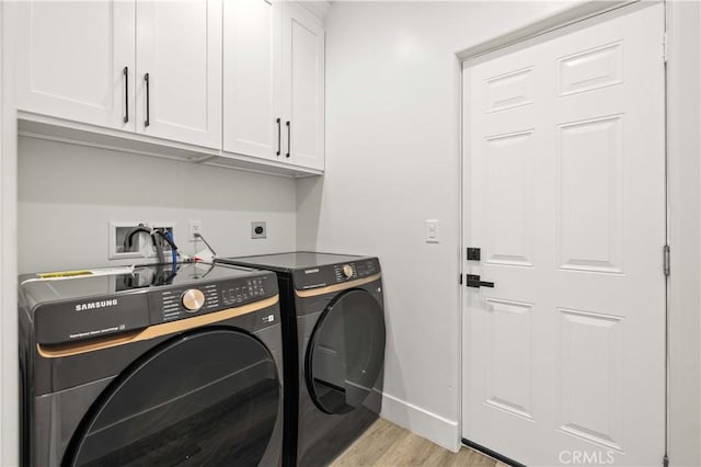 3838 Balmont St, Lancaster, CA 93536 - laundry area featuring cabinet space, light wood-type flooring, and separate washer and dryer