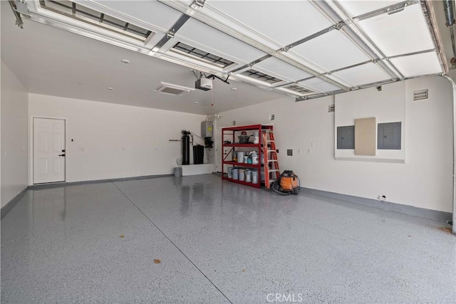 3838 Balmont St, Lancaster, CA 93536 - garage with electric panel, a garage door opener, and water heater