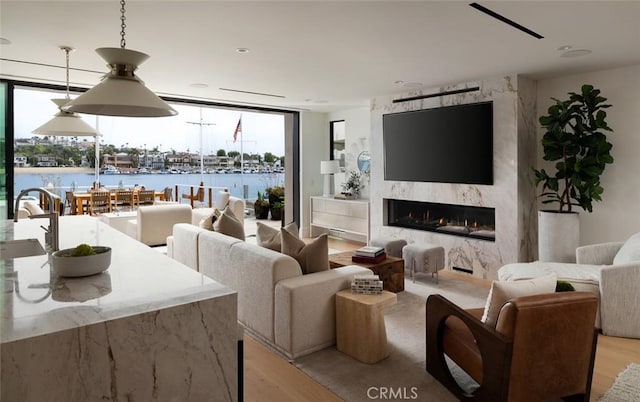 642 Via Lido Nord, Newport Beach, CA 92663 - living room with light wood-style floors, floor to ceiling windows, healthy amount of natural light, and a premium fireplace