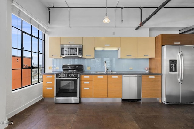 746 S Los Angeles St Unit 1001, Los Angeles, CA 90014 - kitchen with appliances with stainless steel finishes, dark countertops, plenty of natural light, and decorative backsplash