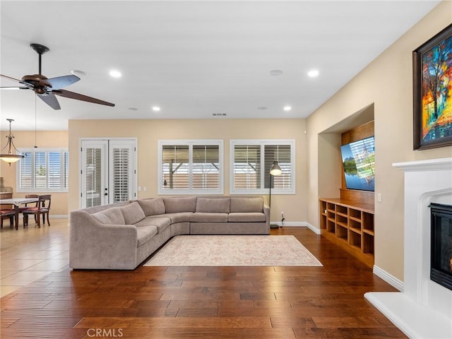 7219 Evening Star Rose Ct, Oak Hills, CA 92344 - living room with hardwood / wood-style floors, a glass covered fireplace, a ceiling fan, and recessed lighting