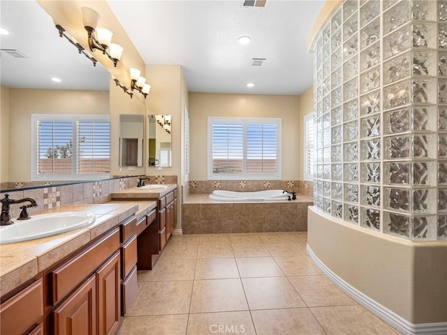 7219 Evening Star Rose Ct, Oak Hills, CA 92344 - bathroom with plenty of natural light, a bath, vanity, tile patterned flooring, and recessed lighting