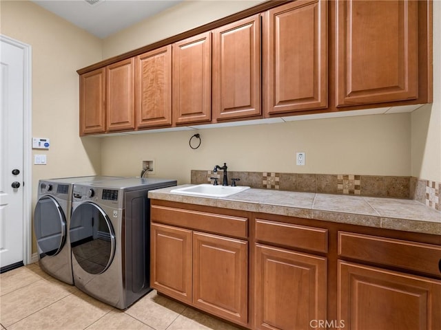 7219 Evening Star Rose Ct, Oak Hills, CA 92344 - laundry room featuring cabinet space, washing machine and clothes dryer, and light tile patterned floors