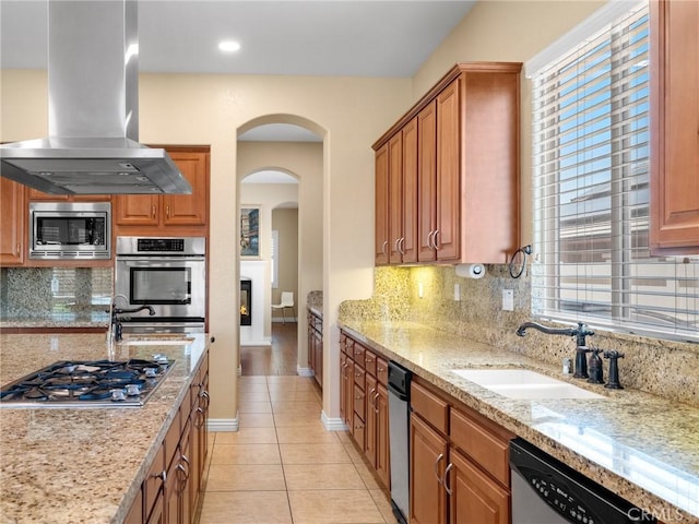 7219 Evening Star Rose Ct, Oak Hills, CA 92344 - kitchen featuring island range hood, stainless steel appliances, tasteful backsplash, light stone countertops, and recessed lighting