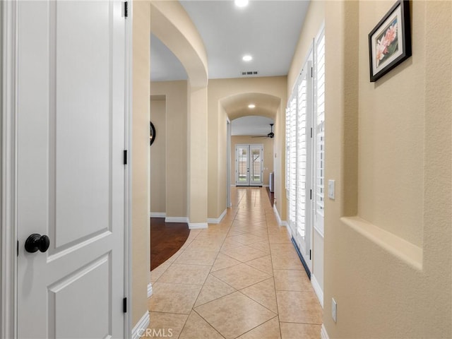 7219 Evening Star Rose Ct, Oak Hills, CA 92344 - hall with arched walkways, light tile patterned floors, and recessed lighting