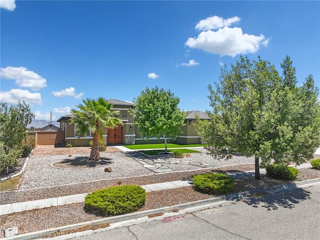7219 Evening Star Rose Ct, Oak Hills, CA 92344 - view of property hidden behind natural elements featuring stucco siding