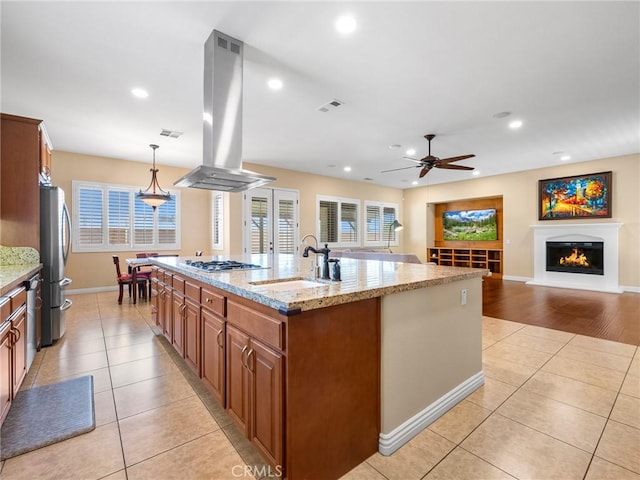 7219 Evening Star Rose Ct, Oak Hills, CA 92344 - kitchen featuring island exhaust hood, appliances with stainless steel finishes, a ceiling fan, light tile patterned floors, and brown cabinetry