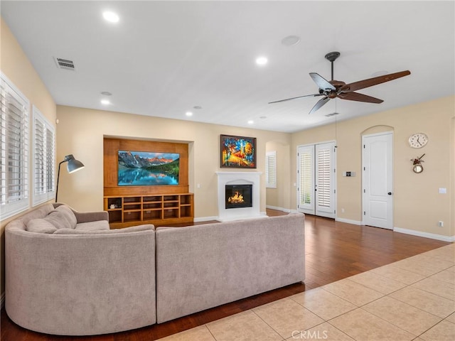 7219 Evening Star Rose Ct, Oak Hills, CA 92344 - tiled living area featuring a glass covered fireplace, ceiling fan, and recessed lighting