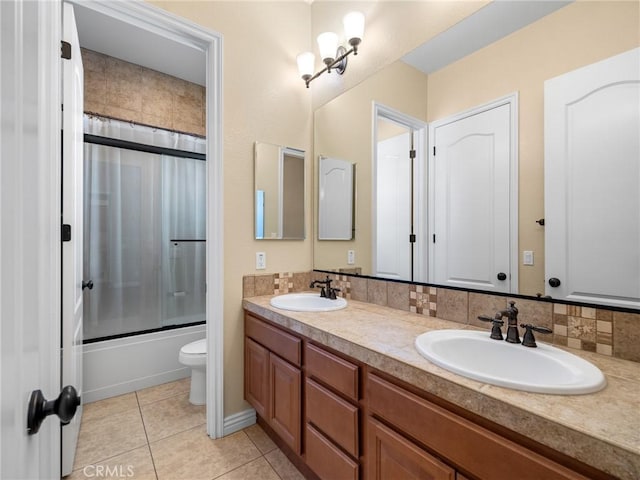 7219 Evening Star Rose Ct, Oak Hills, CA 92344 - bathroom with double vanity, enclosed tub / shower combo, and tile patterned floors