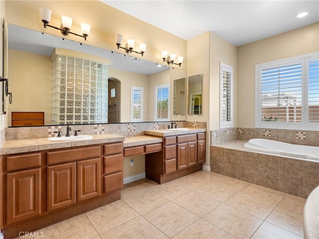 7219 Evening Star Rose Ct, Oak Hills, CA 92344 - bathroom with vanity, tile patterned floors, and a garden tub