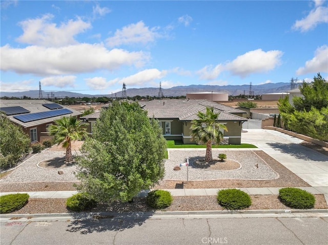 7219 Evening Star Rose Ct, Oak Hills, CA 92344 - view of front of property featuring a mountain view, driveway, and stucco siding