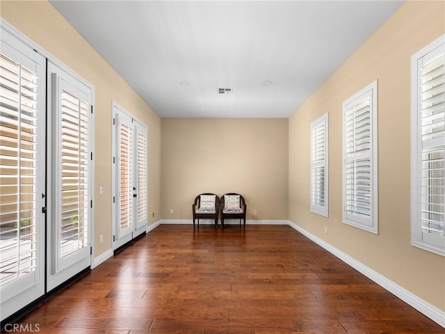 7219 Evening Star Rose Ct, Oak Hills, CA 92344 - living area with dark wood-style flooring and baseboards