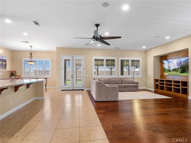7219 Evening Star Rose Ct, Oak Hills, CA 92344 - living area with recessed lighting, ceiling fan, french doors, and light tile patterned floors