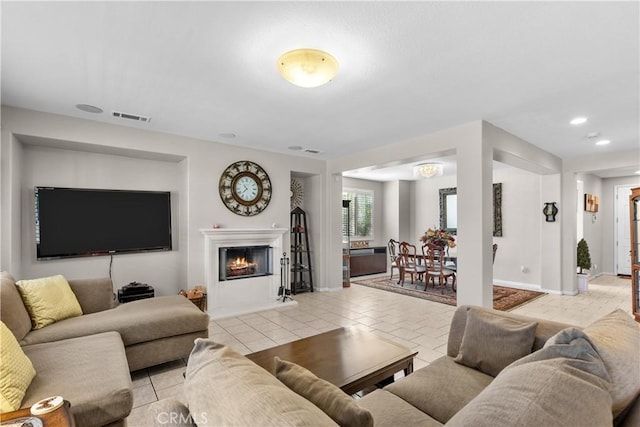 1341 Stanfill Rd, Palmdale, CA 93551 - living area featuring a lit fireplace, light tile patterned floors, and recessed lighting