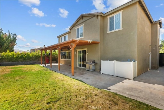 1341 Stanfill Rd, Palmdale, CA 93551 - back of property featuring a patio area, stucco siding, and a yard
