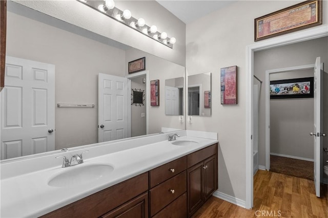 1341 Stanfill Rd, Palmdale, CA 93551 - full bath featuring double vanity, wood finished floors, and shower / tub combo