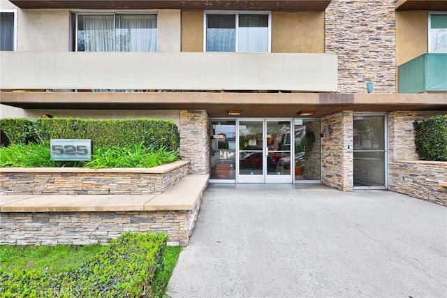 525 N Sycamore Ave Unit 304, Los Angeles, CA 90036 - view of exterior entry featuring stone siding and stucco siding