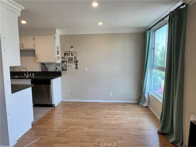 525 N Sycamore Ave Unit 304, Los Angeles, CA 90036 - kitchen featuring stainless steel dishwasher, healthy amount of natural light, dark countertops, light wood-type flooring, and ornamental molding