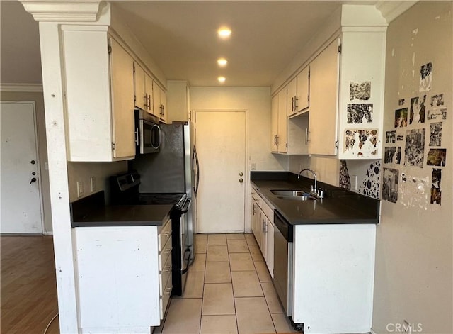 525 N Sycamore Ave Unit 304, Los Angeles, CA 90036 - kitchen featuring appliances with stainless steel finishes, dark countertops, recessed lighting, and light tile patterned flooring