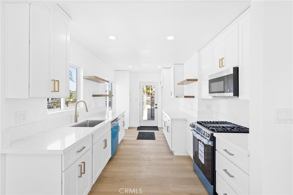 401 S Smith Ave, Corona, CA 92882 - kitchen featuring stainless steel appliances, open shelves, healthy amount of natural light, white cabinetry, and recessed lighting
