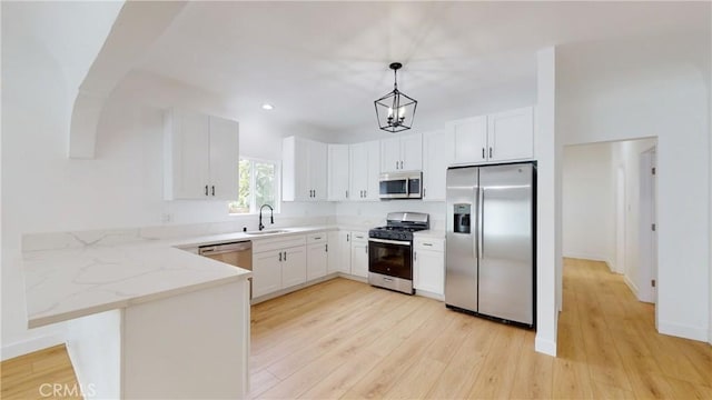 1113 Pacific Ave, Long Beach, CA 90813 - kitchen with stainless steel appliances, light wood finished floors, light stone counters, decorative light fixtures, and recessed lighting