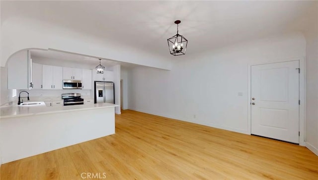1113 Pacific Ave, Long Beach, CA 90813 - unfurnished living room with light wood-style floors and a chandelier