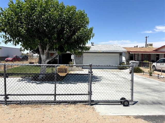 16472 Vine St, Hesperia, CA 92345 - view of front facade featuring an attached garage, a fenced front yard, driveway, and stucco siding