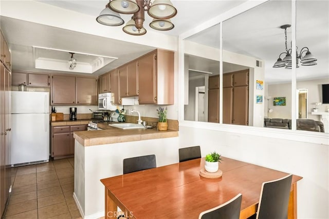 400 Brighton Spgs, Costa Mesa, CA 92627 - dining room with a chandelier, light tile patterned floors, and a raised ceiling
