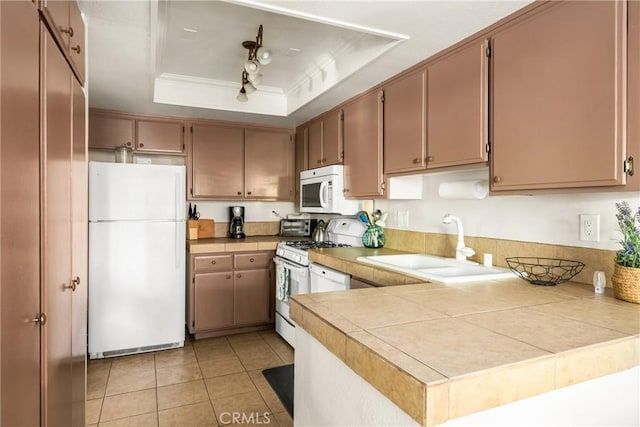 400 Brighton Spgs, Costa Mesa, CA 92627 - kitchen featuring white appliances, a raised ceiling, ornamental molding, a peninsula, and light tile patterned floors