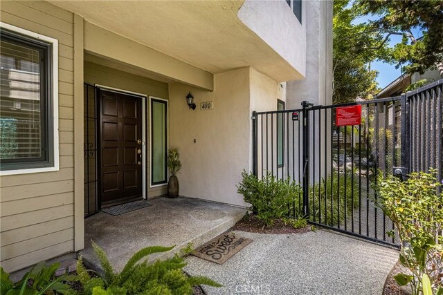 400 Brighton Spgs, Costa Mesa, CA 92627 - doorway to property featuring stucco siding and a gate
