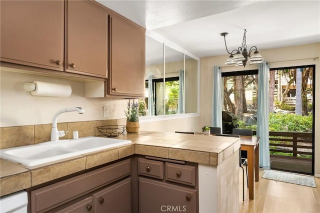 400 Brighton Spgs, Costa Mesa, CA 92627 - kitchen featuring a peninsula and a chandelier