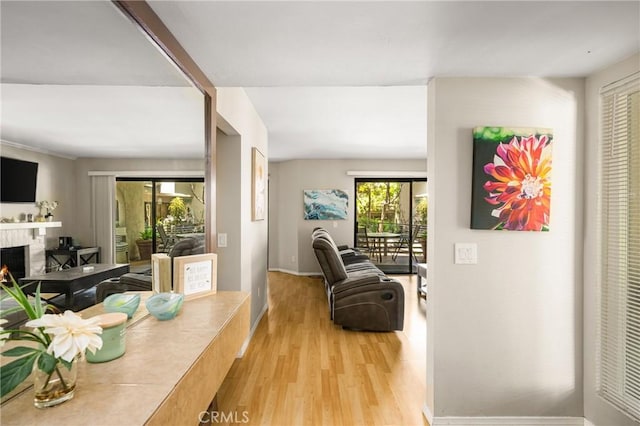 400 Brighton Spgs, Costa Mesa, CA 92627 - dining space with light wood-type flooring and a lit fireplace